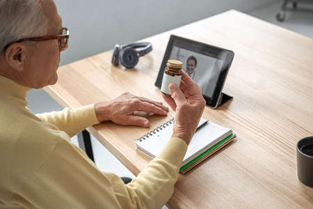 Caucasian senior man listening information and having support with male therapistの写真素材