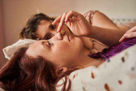 couple dating and enjoying of tender sensual moment together at the bedroomの写真素材