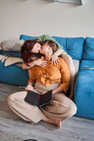 Happy  couple kissing each other while spending time at homeの写真素材