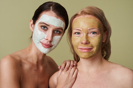 Diverse women with facial masks looking at the camera with calm expressionの写真素材