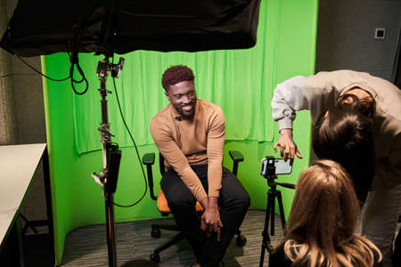Presenters and video camera operator working in studioの写真素材