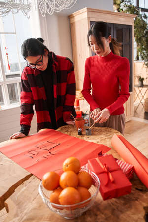 Asian man looking attentively at the hieroglyphs his woman drawing