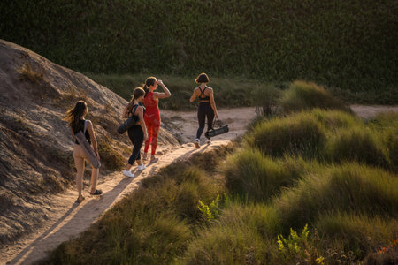 Full length view of the group of yoga girls walking at theの写真素材