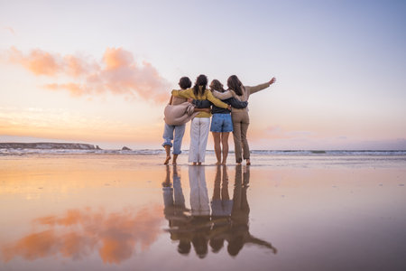 Back view of the four girls embracing and enjoying of theの写真素材