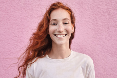 Portrait view of the red haired woman smiling cheerfully atの写真素材