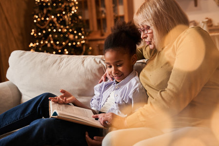 Mother reading book to her children in the evening in theの写真素材