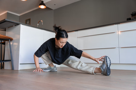 Full length view of multiracial woman stretching to touchの写真素材