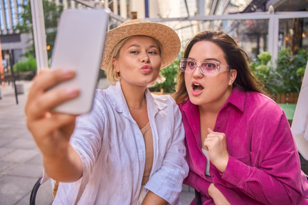 Body positive female friends making selfie at the smartphoneの写真素材