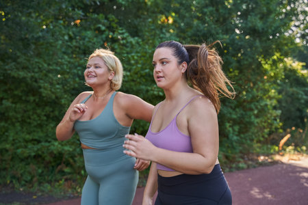 Two happy girls running with each other at the morning