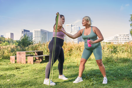 Young curvy women training with resistance bands together toの写真素材