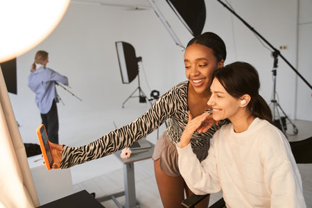 Make up artist woman giving five to her multiracial model