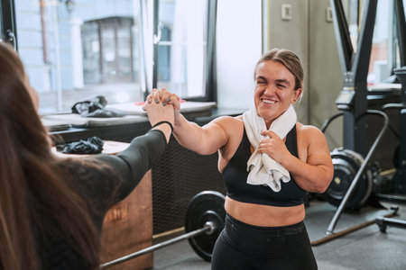 Midget woman with towel at her neck laughing and giving five