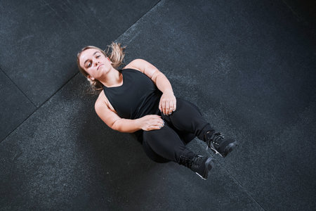 Woman with genetic disorder laying at the back at the floor