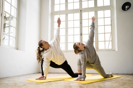 Mom and daughter feeling concentrated while doing aerobicsの写真素材