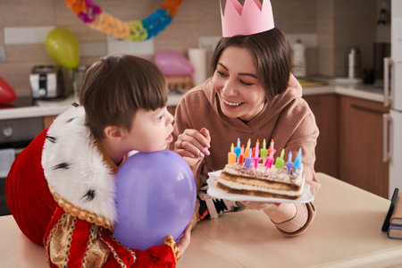 Boy with Down syndrome looking away while his overjoyedの写真素材