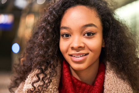 Happy and beautiful multiracial woman smiling while looking at the cameraの写真素材