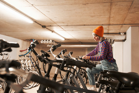 Involved woman checking bike while preparing repairing it at the bicycle workshopの写真素材