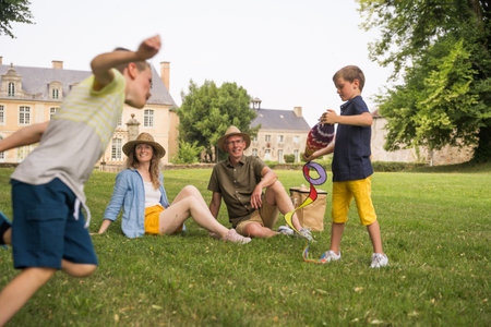 Happy harmonious family of mother, grandfather and two little boys having activities togetherの写真素材