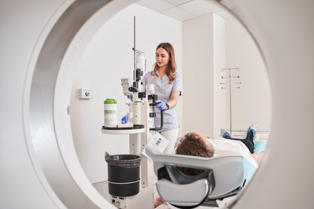 Female doctor control and monitor MRI or CT scan with male patientの写真素材