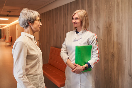 Doctor talking with female patient about medical examination or test resultsの写真素材