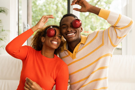 Portrait of happy african american couple posing with Christmass toysの写真素材