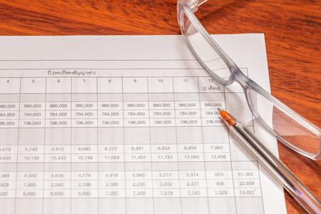 accounting records report document with glasses and penの写真素材