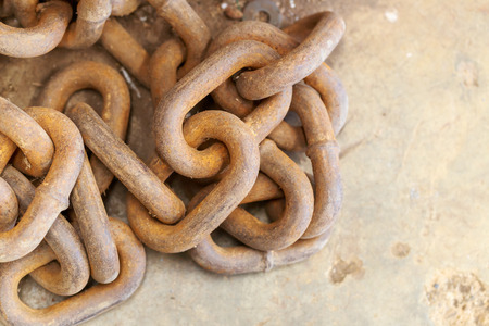 rusty iron chain on concrete floor