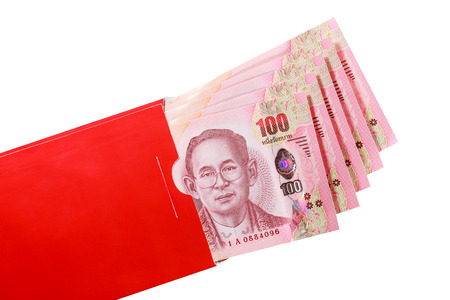 Thai bank note in red envelope for Chinese new year gift on white backgroundの写真素材