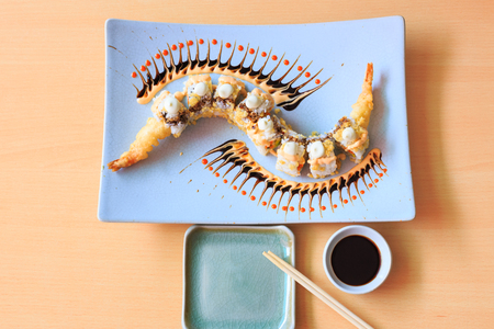 ancy sushi on ceramic plate on wood table top viewの写真素材