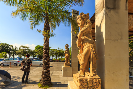 ULUWATU, BALI, INDONESIA - MARCH 26 : Unidentified Tourist standing beside goddess statue at the Garuda Wisnu Kencana Cultural Park on March 26, 2014 in Uluwatu, Bali, Indonesia.のeditorial素材