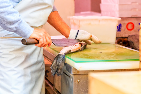 worker cutting salmon on a boardの写真素材
