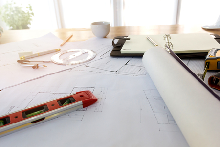 Blueprints, Hardhat, Glasses, Stickers, Construction level, Pen in architecture office.の写真素材