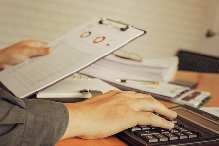 Administrator business man financial inspector and secretary making report, calculating or checking balance.の写真素材