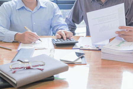 Administrator business man financial inspector and secretary making report, calculating or checking balance.の写真素材