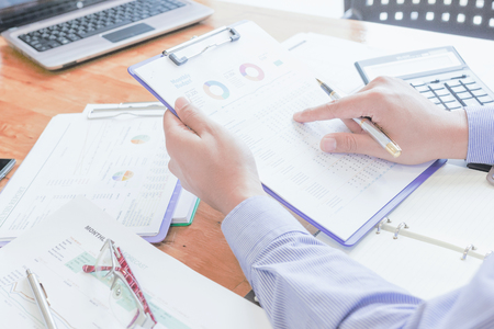 Administrator business man financial inspector and secretary making report, calculating or checking balance.の写真素材