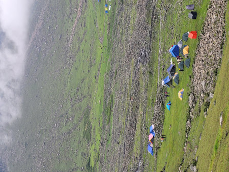 Aerial view of a group of tents on the slope of the mountain.の写真素材
