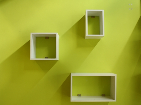 White shelf on a green wallの写真素材