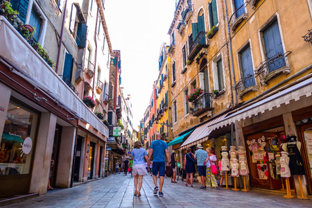Venice, Italy-July 7, 2016: Historic buildings on the street of Venice where is full of shops and restaurants on the both sideのeditorial素材