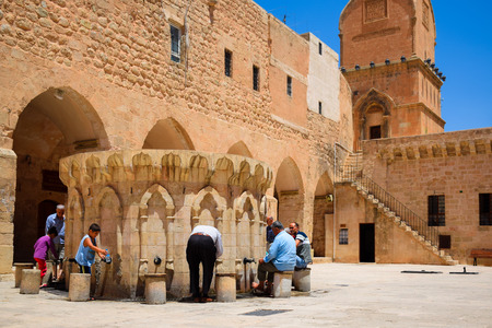 Mardin, Turkey-July 6, 2015: Muslim people are washing their hands and feet before going inside the mosque for prayer at Ulu Camii (Grand mosque) of Mardin, Turkeyのeditorial素材