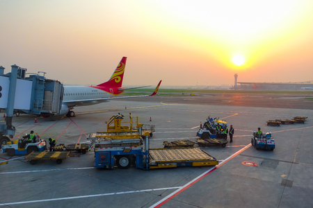Beijing, China-May 19, 2016: The aircraft of Hainan Airlines is parked at the aerobridge of Beijing capital international airport with ground handling equipment and staffs aroundのeditorial素材