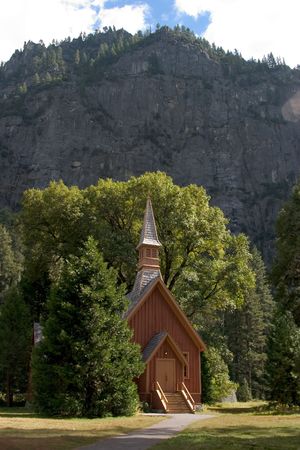 Small church at the base of a sheer wall of granite, in Yosemite Valley.の写真素材
