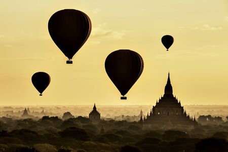 Tourist Balloons Flying over Great Pagoda with Morning Mist at Sunrise, Bagan, Myanmarの写真素材