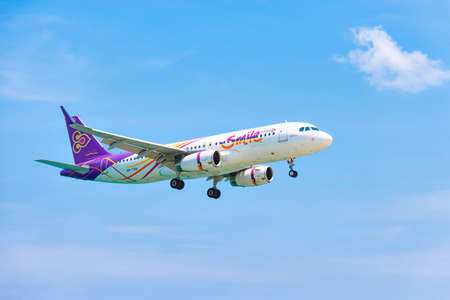 Aircraft Airbus a320 of Thai Smile Airways landing on runway at Phuket International Airport in Clear Sky, Phuket Island, Thailandのeditorial素材