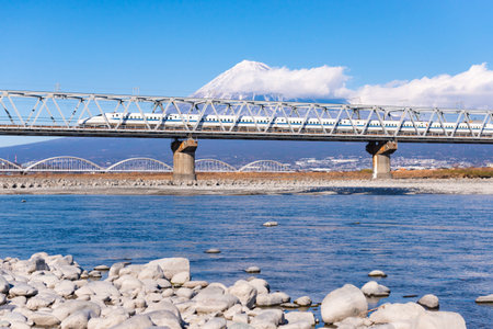 Japan - February 2, 2019 : High Speed Bullet Train Tokaido Line ran on the Bridge across Fuji River with Fuji Mountain Background in winter, Fuji City, Shizuokaのeditorial素材