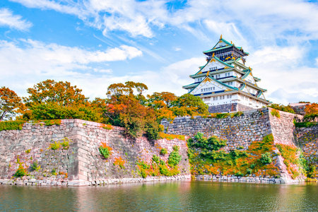 Japan - November 20, 2019 : Osaka Castle among Colorful maple and Sakura Trees in the garden of Osaka Castle Park in autumn, Osakaのeditorial素材