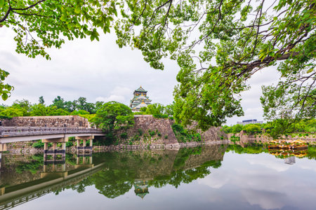 Japan - July 15, 2019 : Main Building of Osaka Castle with Green Trees around castle in summer, Osaka