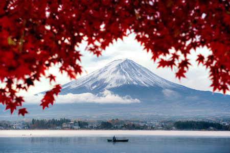 Fuji mountain and Fisherman boar with Red Maple Leaves in autumn at Kawaguchiko Lake, Japanの写真素材