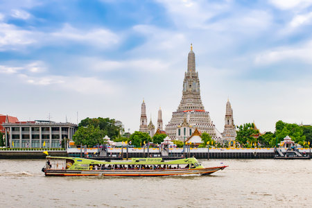 Thailand - July 14, 2019 : Tourist sightseeing boat sailing in the Chao Praya River with Pagoda of Wat Arun Temple Background , Bangkokのeditorial素材