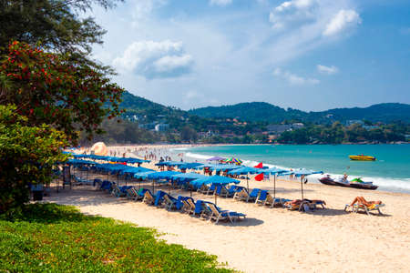 Thailand - April 1, 2019 :  Colourful Beach Umbrellas, Chairs and Beds on the white sand beach of Nai Harn beach in Summer, Phuketのeditorial素材