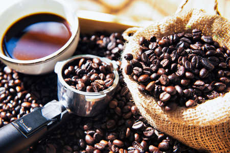 Coffee Bean in the Sack and Wooden Tray with  A cup of Coffeeの写真素材